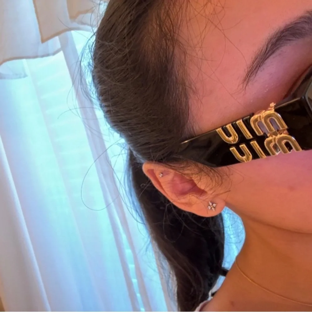 Miu Miu Glossy Black Cat-Eye Sunglasses with Pink Case